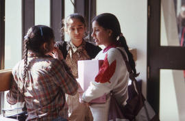 Photograph of students talking in a hallway in E building