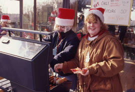Photograph of Two People at the BBQ During the Christmas Tree Sale and Family Event