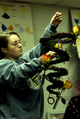 A photograph of a Retail Floriculture student in a lab