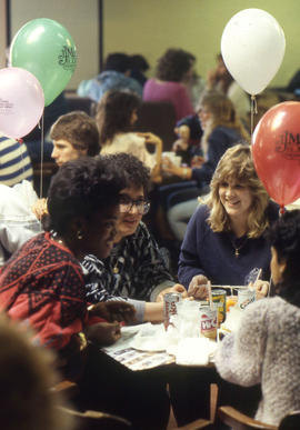 Photograph of students socializing at a table in CAPS
