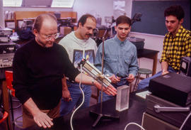 Photograph of a faculty doing a demonstration for students in the Electronics lab