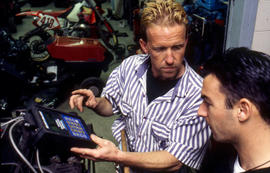 Photograph of Robert Smith and student performing engine diagnostics