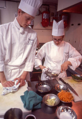 Photograph of two Culinary program students cooking together