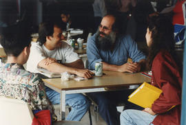 Photograph of John Steckley seated with students in Lakeshore cafeteria