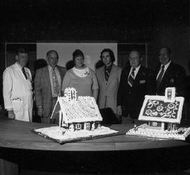 Photograph of Gordon Wragg and Igor Sukor Displaying the Gingerbread Houses to the Hospital Execu...