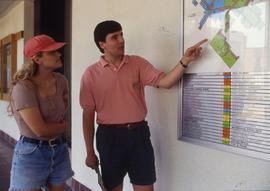Photograph of two students looking at a campus map