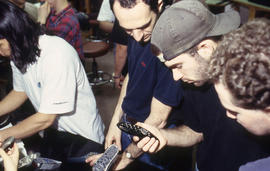 A photograph of Industrial Design students examining designs