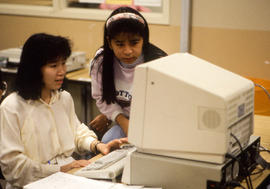 Photograph of two students working together at a computer