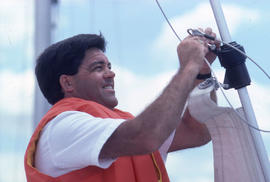 Photograph of a crew member attaching a line on a sailing boat