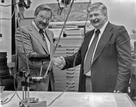 Photograph of Bob Higgins Shaking Someone's Hand
