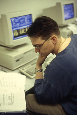 Photograph of a student using a computer in the lab to work on an assignment