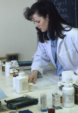Photograph of a Pharmacy Assistant Working on a Prescription Order