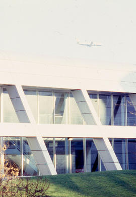 Photograph of a plane flying over the N building