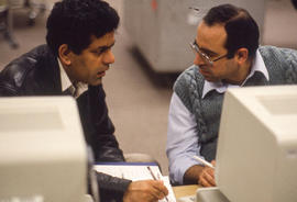 Photograph of two adult learners at a computer workstation