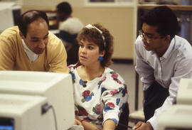 Photograph of an instructor and students in a computer lab