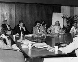 Photograph of Staff Having a Meeting in the President's Boardroom