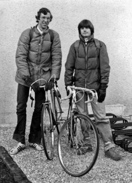 Photograph of Two Students Standing Next to Their Bikes