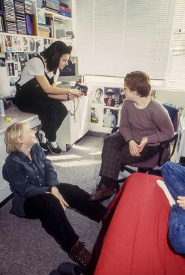 Photograph of students gathered together and chatting in a residence dorm