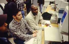 A photograph of students working together at a computer