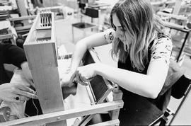 Photograph of a Student Using a Loom in her Weaving Class