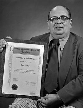 Photograph of Igor Sukor Holding his Award he Recieved from the Canadian Restaurant Association F...