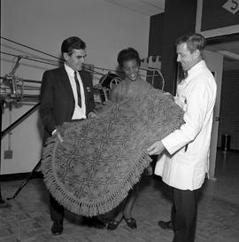 Photograph of a rug being displayed during open house