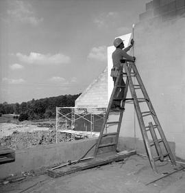 Photograph of an electrician working outside the building