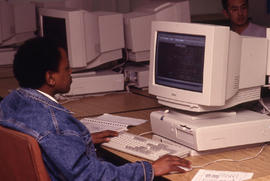 A photograph of a student at a computer in the Technology lab