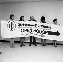 Photograph of students and staff holding the Queensway Open House sign