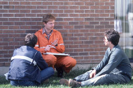 Photograph of an instructor and students talking outside