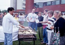 Photograph of faculty and staff line up for food