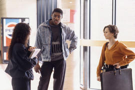 Photograph of Three Students Talking in a Hallway