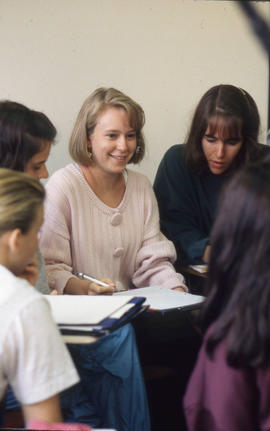 Photograph of Students Talking in a Classroom