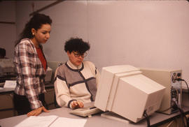 Photograph of two students working together at a computer station