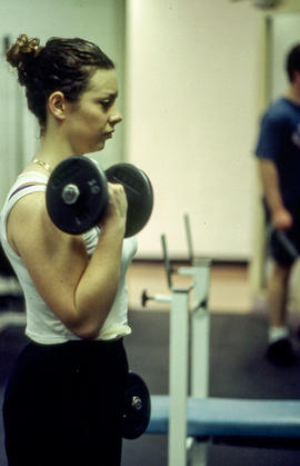 A photograph of a student doing a bicep curl with weights