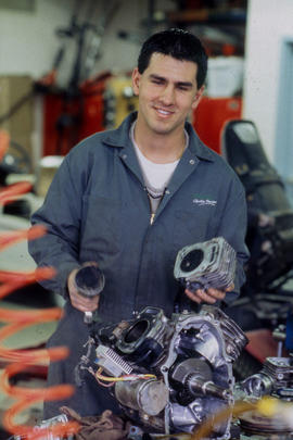 Photograph of student working on an engine