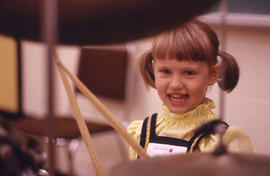 Photograph of a child playing drums