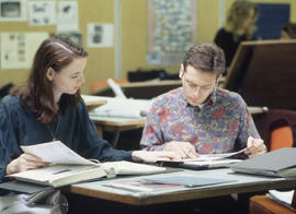 Photograph of Two Students Talking About Their Assignment