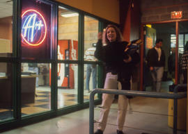 Photograph of a student standing outside of the A+ in the Student Centre