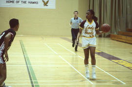 Photograph of a Lady Hawks playing basketball against Seneca in the gym
