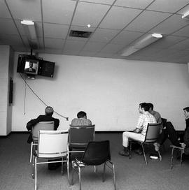 Photograph of students watching a video feed from the Instructional Materials Centre
