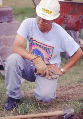 Photograph of a Landscape Technology student kneeling in the Arboretum