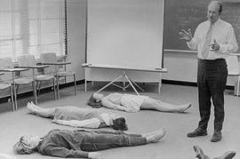 Photograph of Rex Sevenoaks teaching breathing techniques to his students