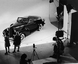 Photograph of Photography Students Doing a Photoshoot with a 1970 Cadillac Convertible
