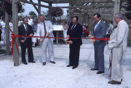 Photograph of four dignitaries cutting the ribbon for the opening of the demonstration gardens