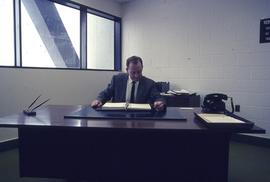 Person at desk in Registrar office in E/F building : [photograph]