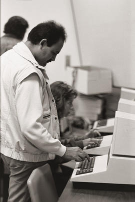 Photograph of persons at a machine