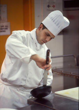 Photograph of a culinary student in the kitchen