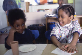 Photograph of children seated at a table during snack time