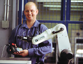 Photograph of an unknown staff with a robot machine